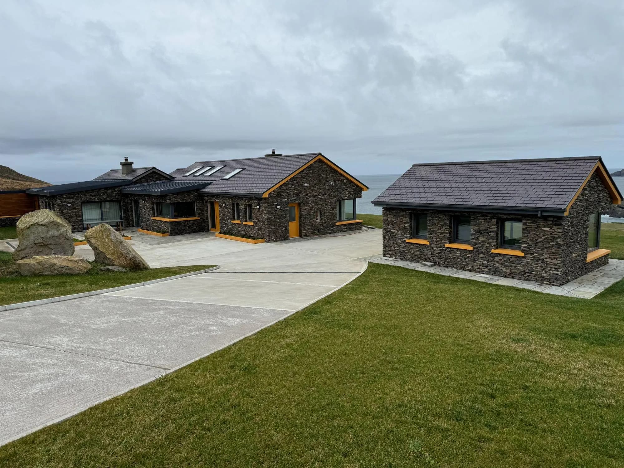 Stone-clad home and outbuilding after the rebuild