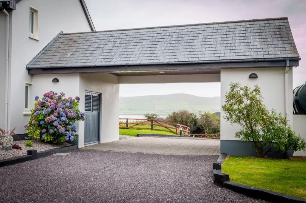 Covered entrance looking out to a hillside and the water
